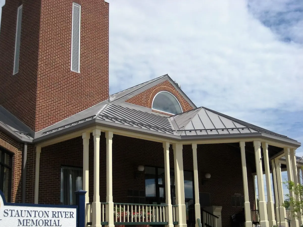 Skilled roofing craftsmen working on a residential roof in Charles City